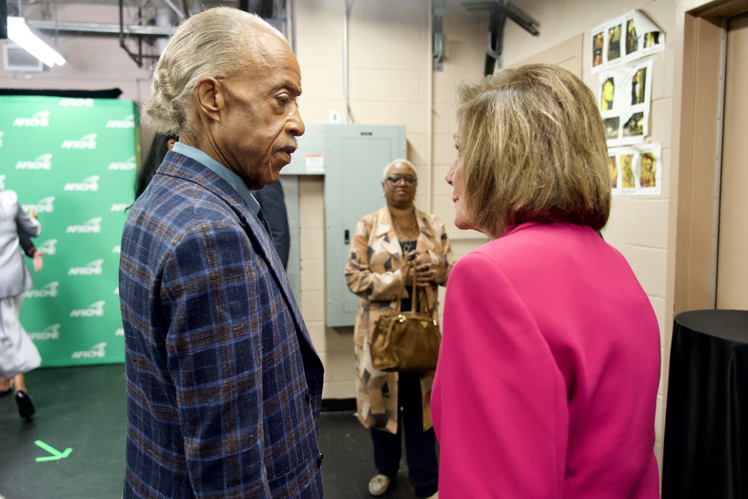 Rev. Al Sharpton speaks with Speaker Emerita Nancy Pelosi backstage at the AFSCME celebration