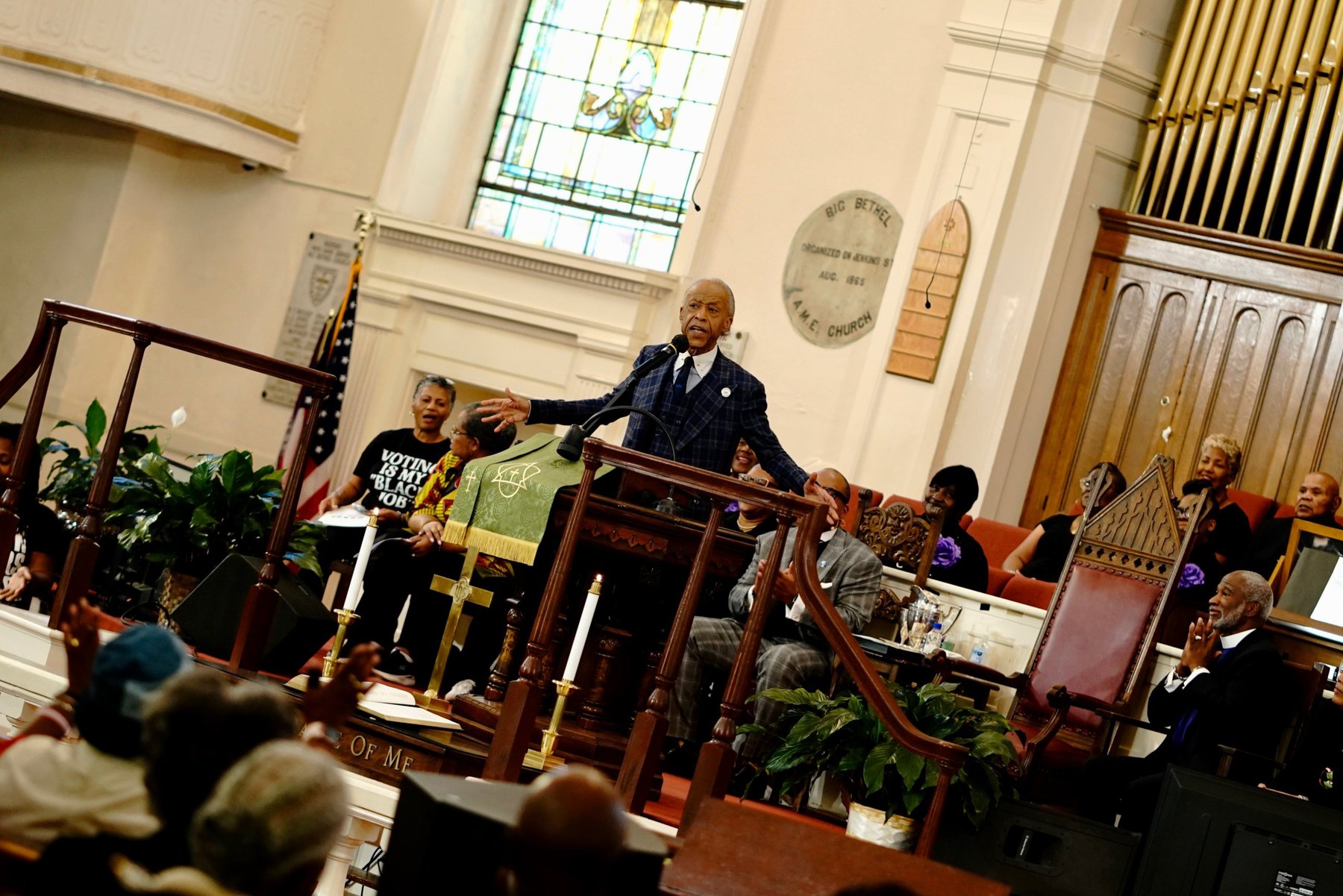 Rev. Al Sharpton preaches with arms outstretched as the Big Bethel congregation responds