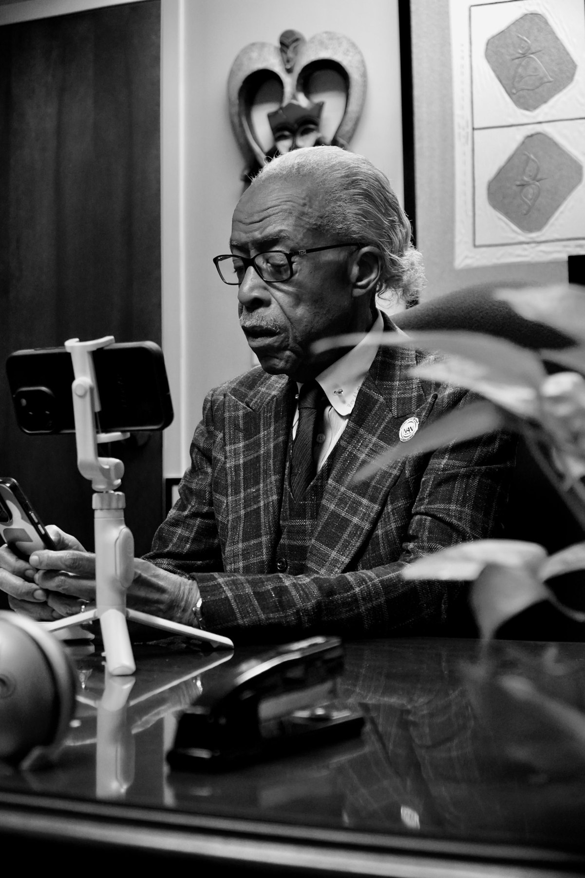 Rev. Al Sharpton reads a viewer question on his phone during PREACH on MS NOW
