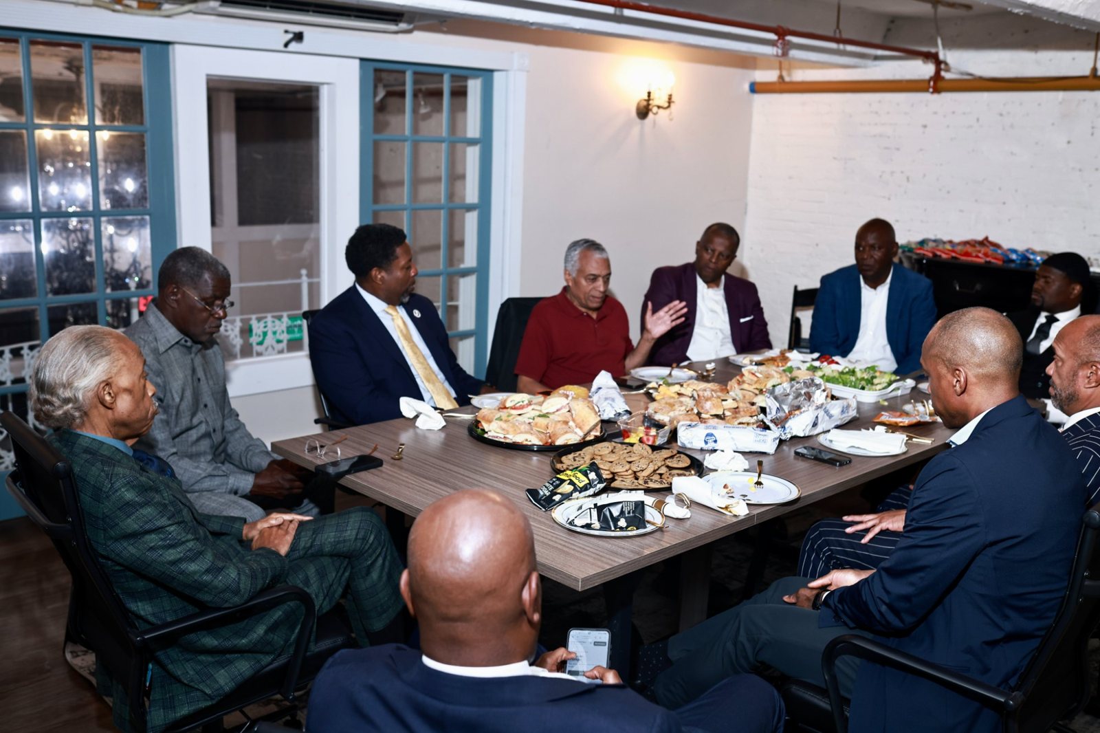 Mayor Ras Baraka in discussion with leaders around the table at the House of Justice