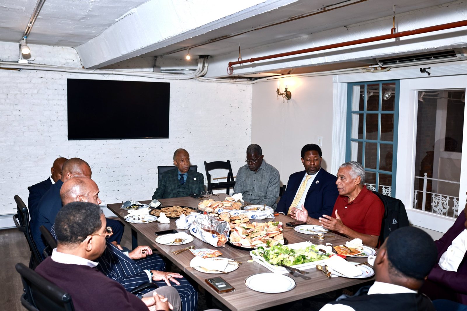 Rev. Al Sharpton, Mayor Ras Baraka, and community leaders seated together at the House of Justice