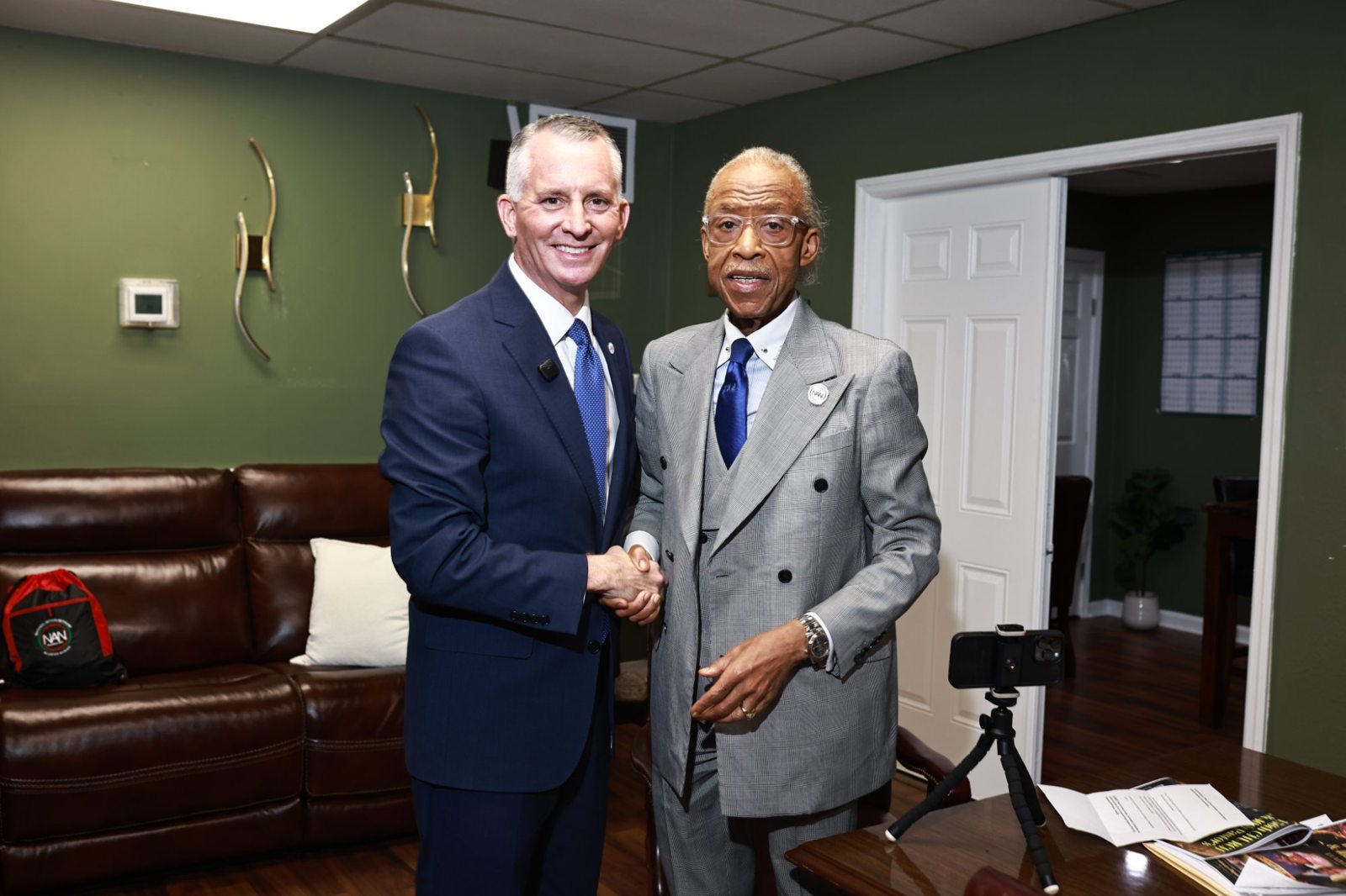 Rev. Al Sharpton shakes hands with former U.S. Congressman David Jolly ahead of the Bethel anniversary celebration