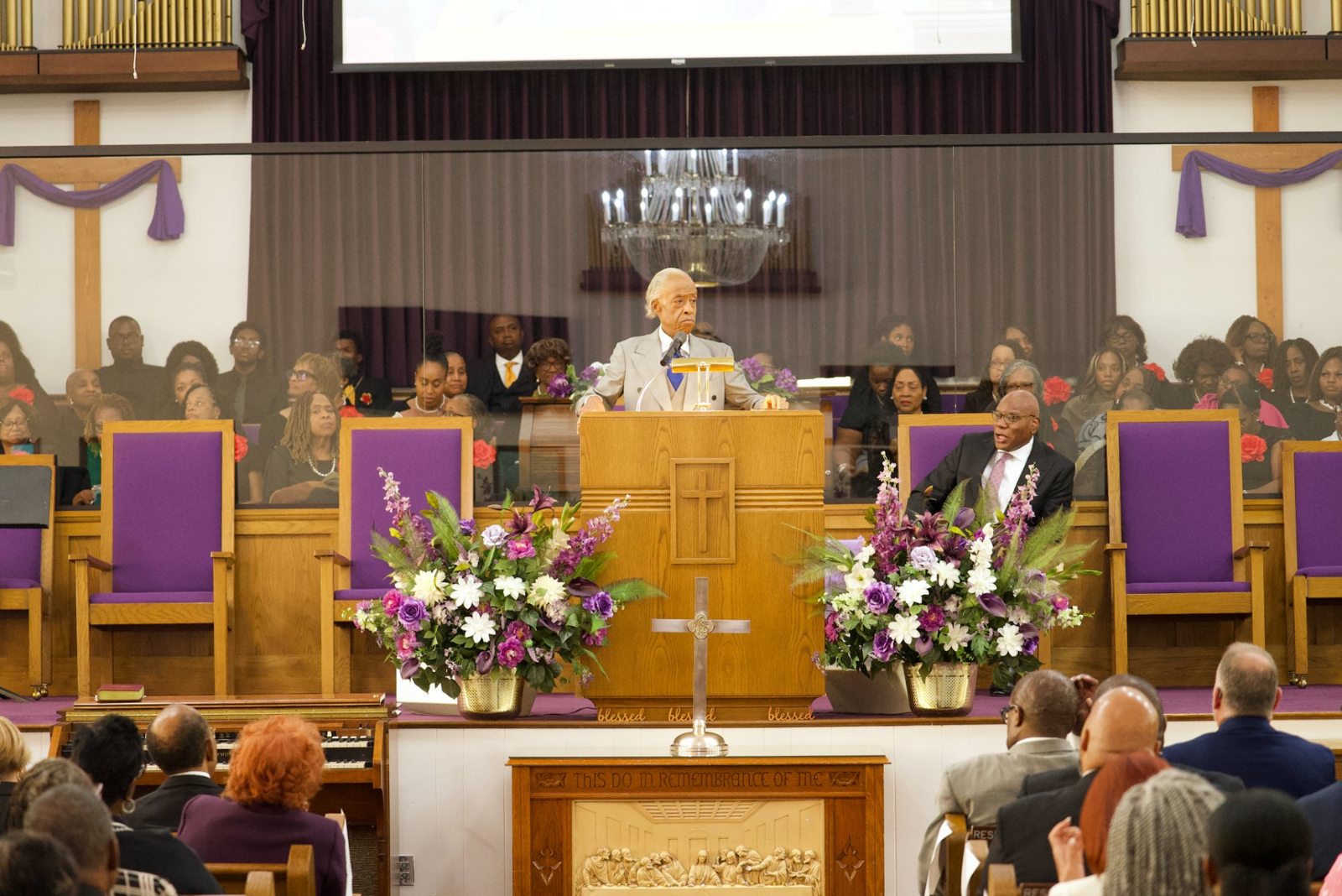 Rev. Al Sharpton preaching from the pulpit as Pastor R.B. Holmes Jr. looks on at Bethel Missionary Baptist Church