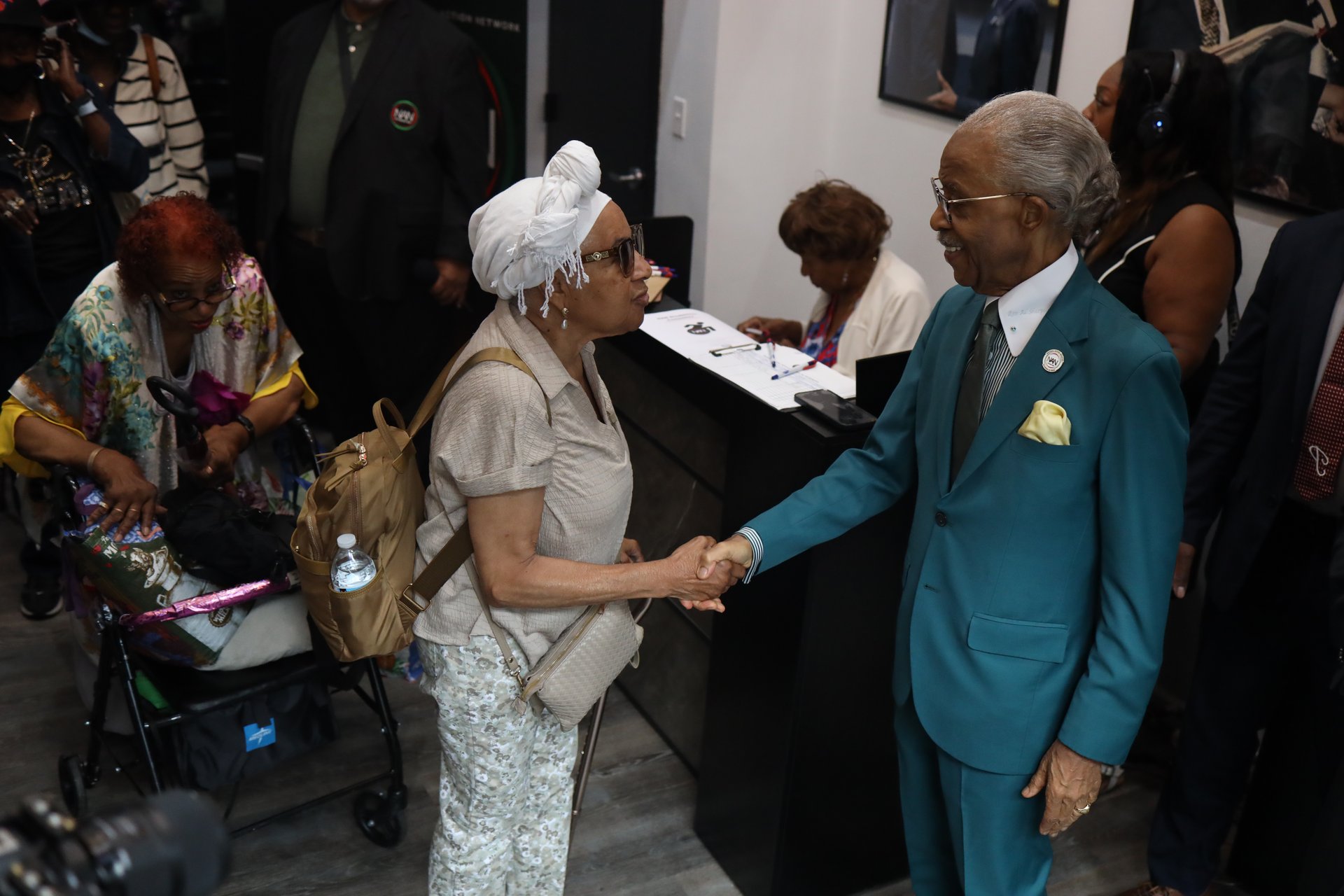 Rev. Al Sharpton greets a community member