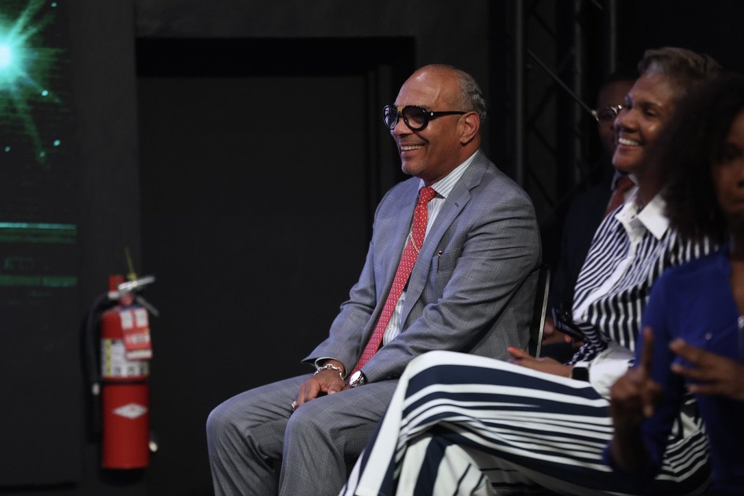 A guest smiles from the audience at the first rally