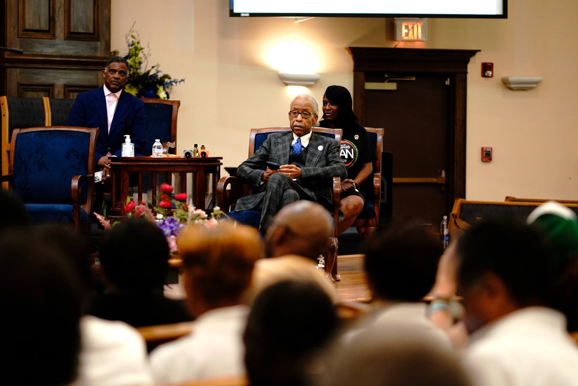 Rev. Al Sharpton seated on the Fairfield stage before a full sanctuary