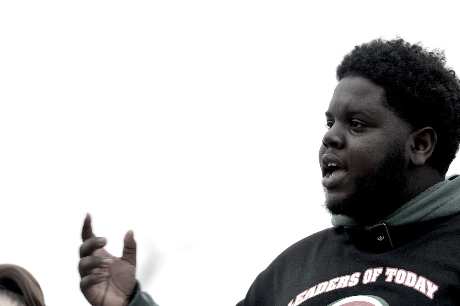 Ousmane Diallo speaking, wearing a Leaders of Today shirt
