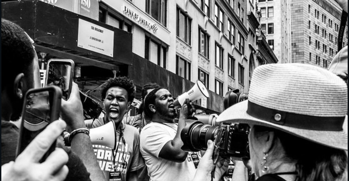 Ousmane Diallo speaks with a megaphone at March for Our Lives