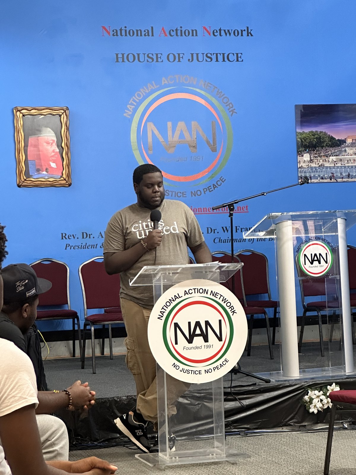 Ousmane Diallo speaking at a National Action Network House of Justice podium in Harlem