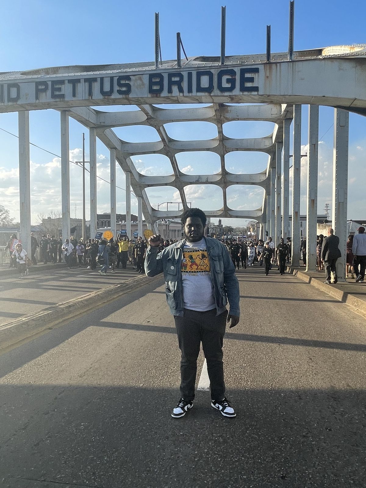 Ousmane Diallo on the Edmund Pettus Bridge in Selma, fist raised