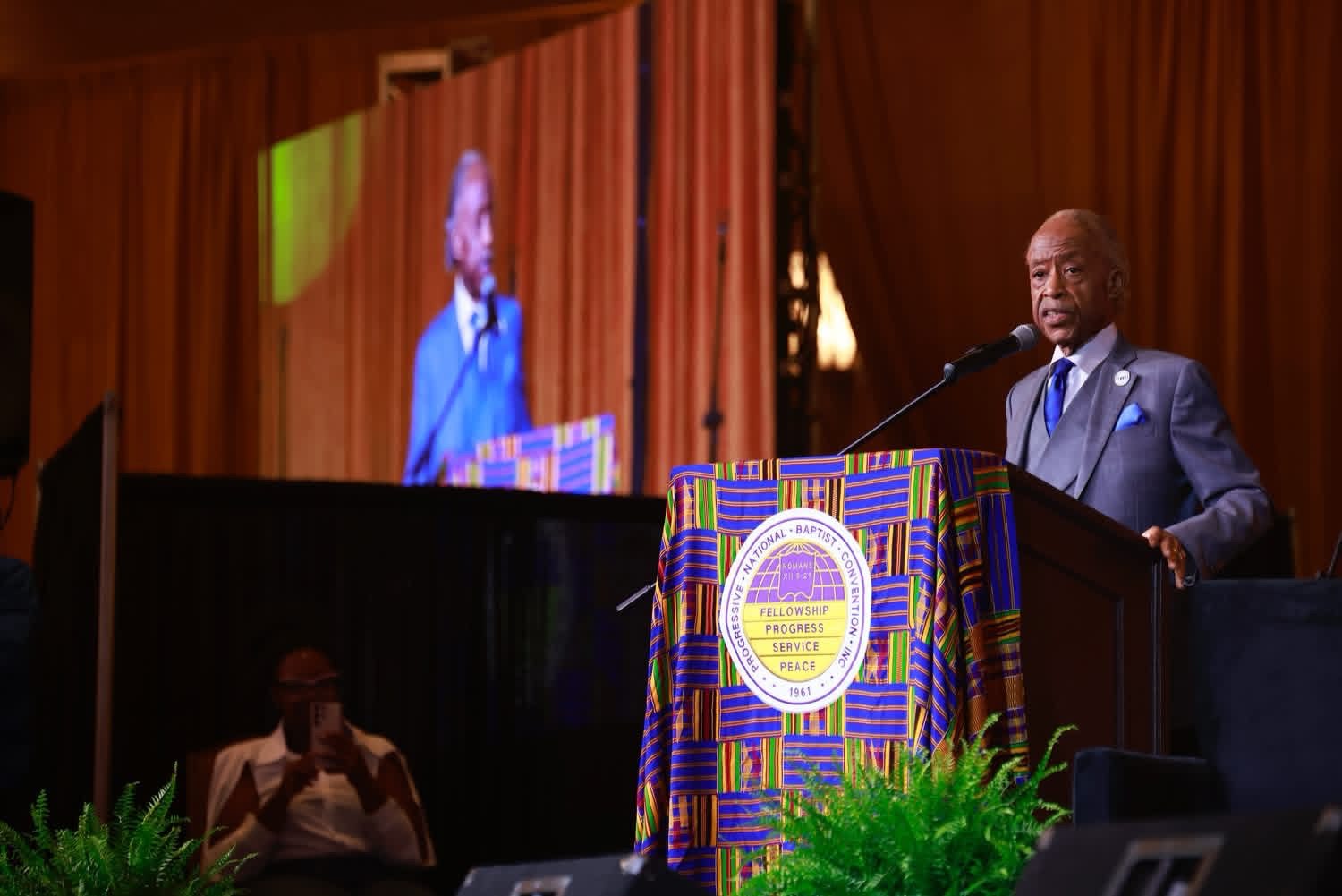 Rev. Al Sharpton addresses the convention, projected on the main screen