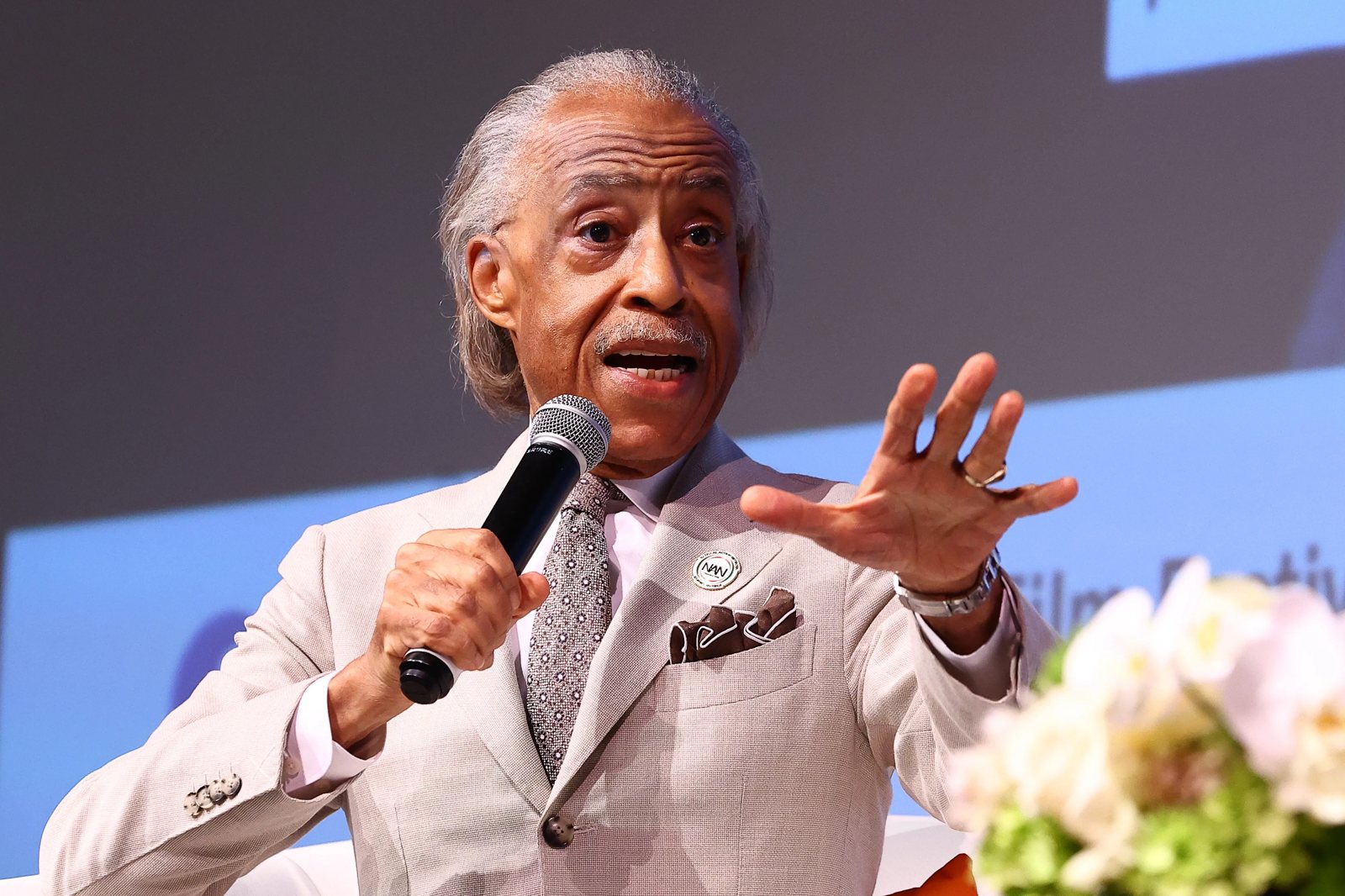 Rev. Al Sharpton speaks into a microphone