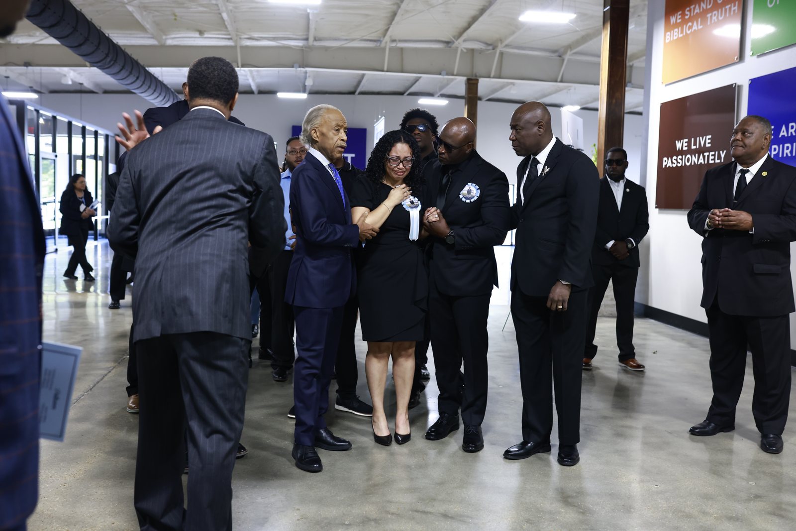 Rev. Al Sharpton stands with the Wells family and Attorney Ben Crump